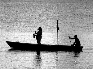 Jarundy. who plays his sax in a boat to the setting of the sun